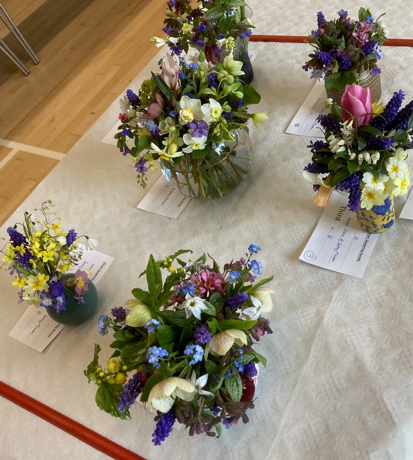 Spring flower arrangements displayed at the Elham Gardening Society Spring Show 2026