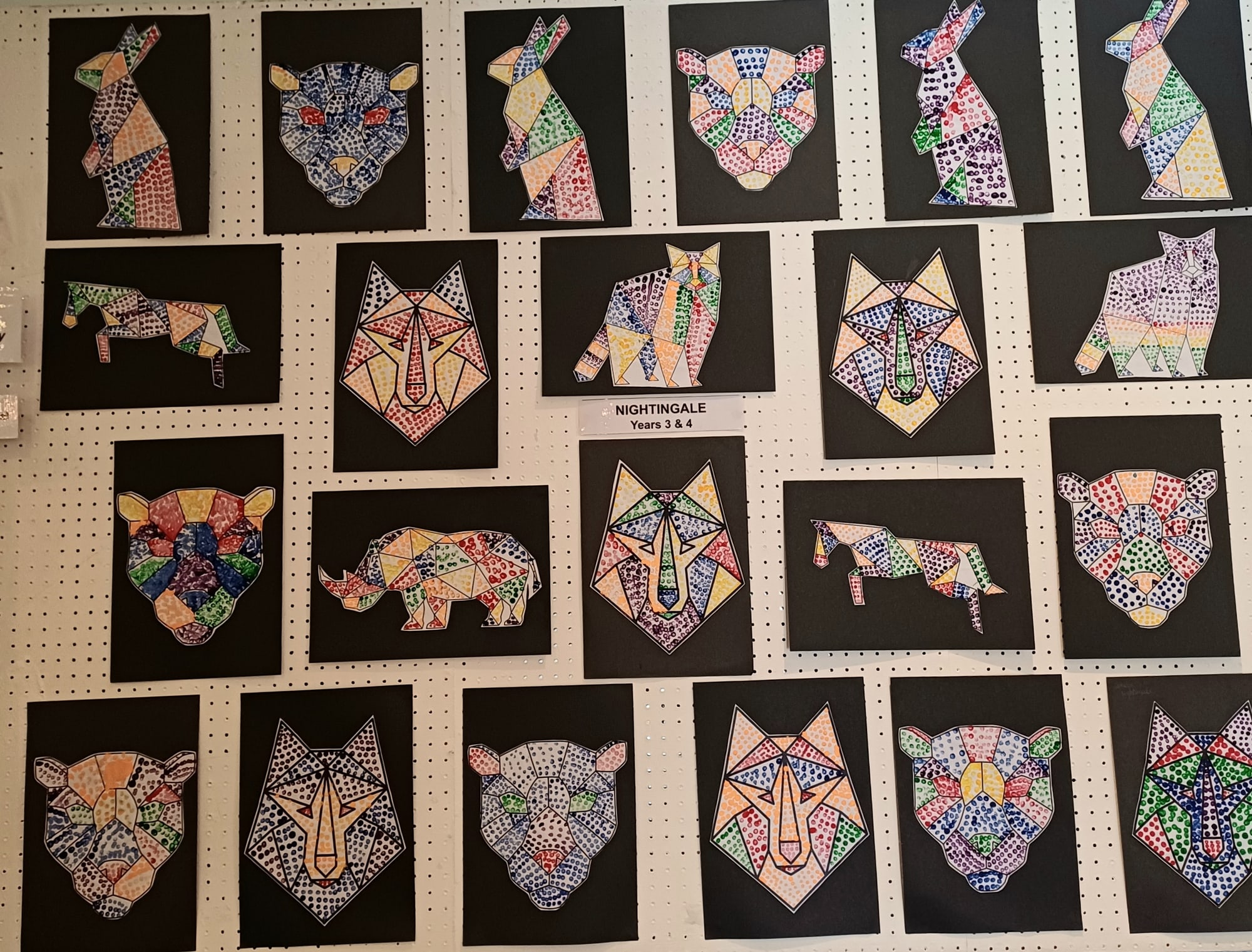 Colourful geometric animal drawings by pupils displayed for the Anna Clayton Trophy