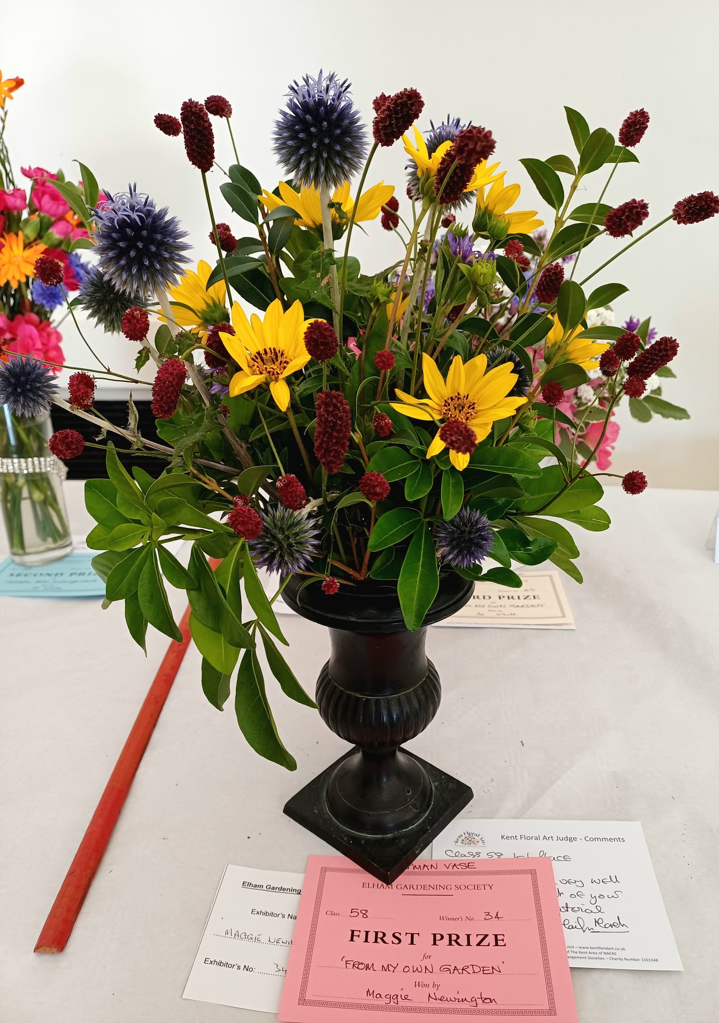 Yellow, blue, and burgundy flowers arranged by Maggie Newington for the From My Own Garden class