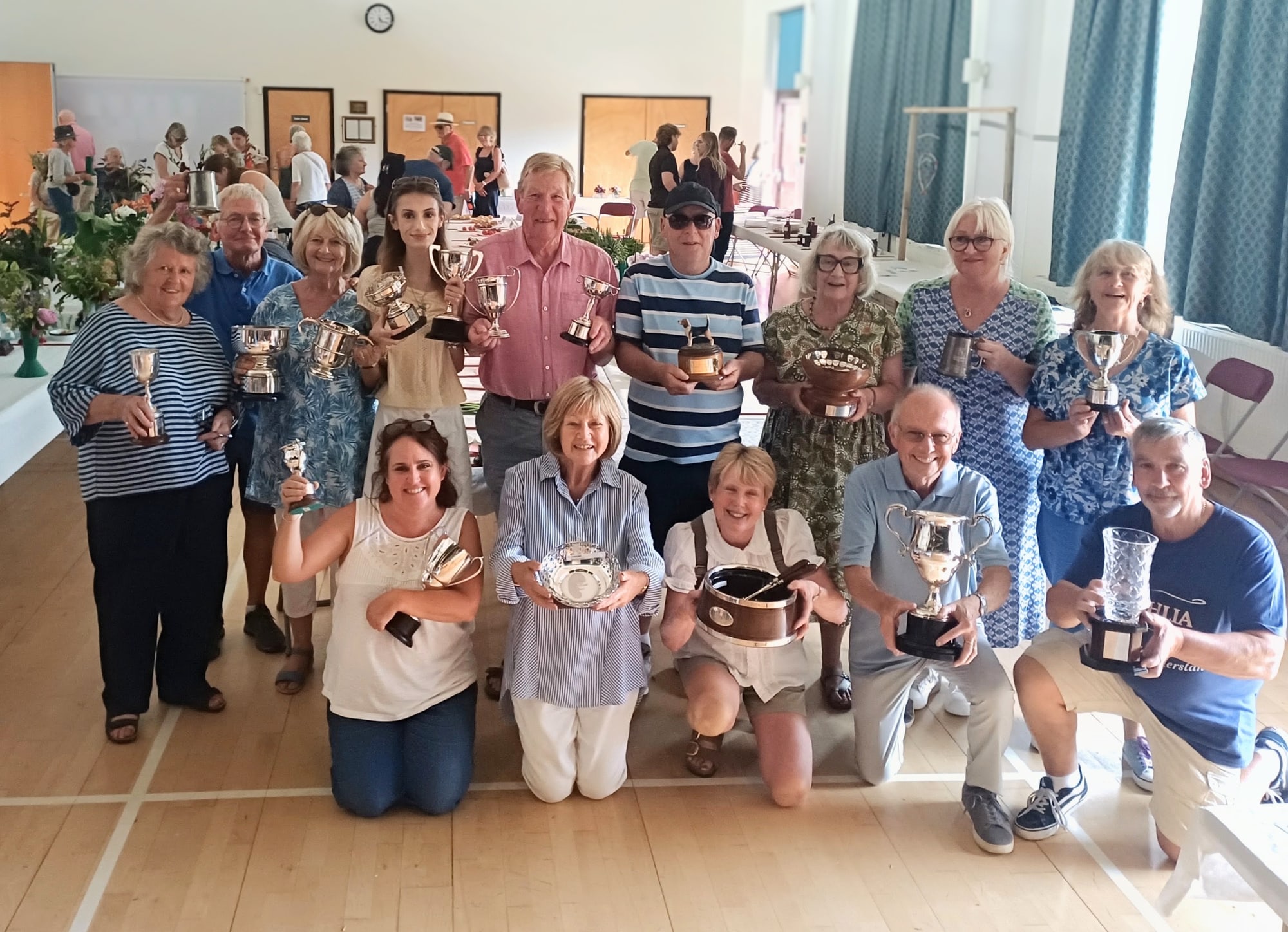 A group of Summer Show 2026 trophy winners holding their awards in Elham Village Hall